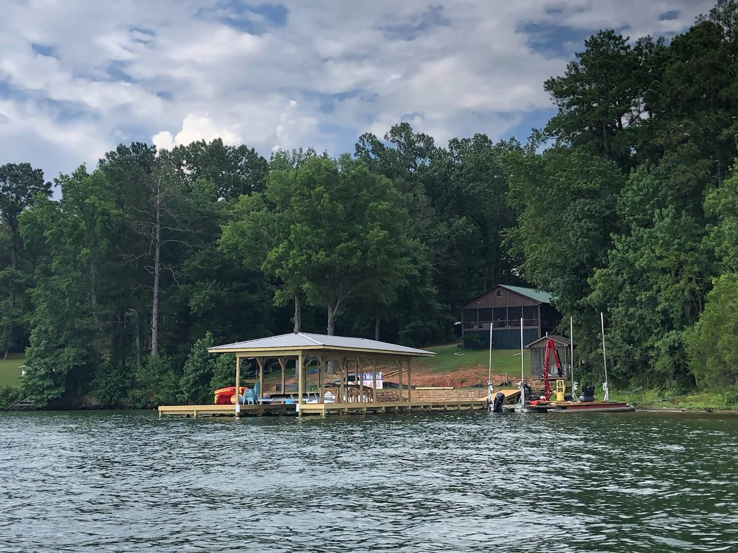 Covered dock and wooded shoreline viewed from the water